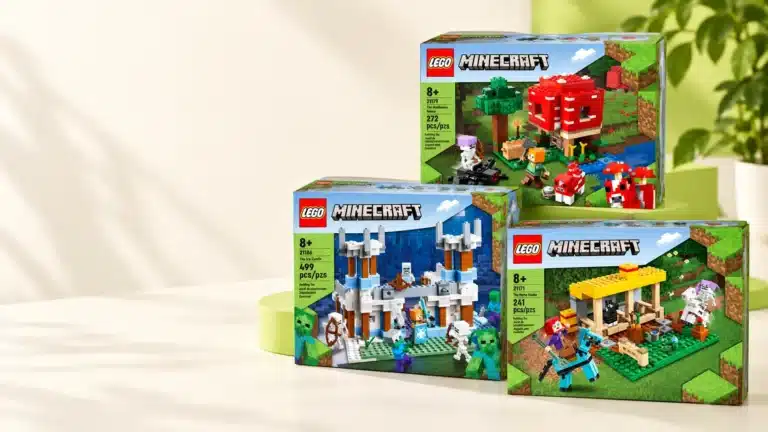 Three LEGO Minecraft sets stacked on a cream studio table